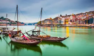 Porto cityscape on the Douro River with traditional Rabelo boats in Portugal